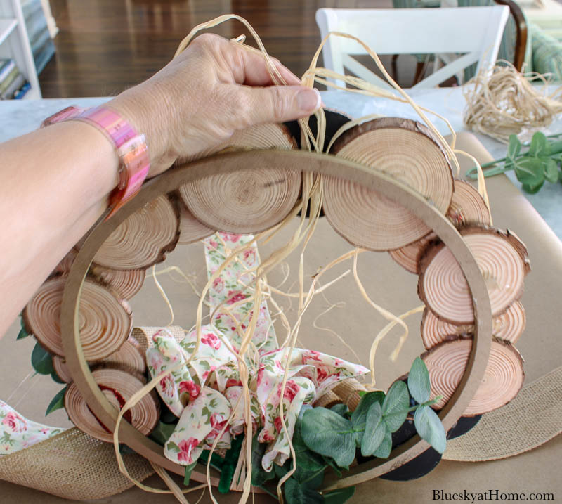 hanging wood slice wreath with raffia