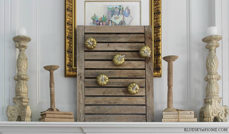 early fall mantel with teak shutter on mantel with pumpkins