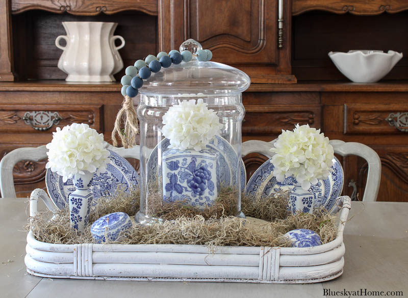 blue and white ginger jar inside cloche