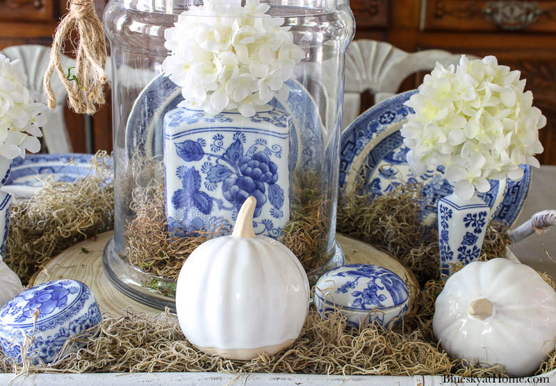 blue and white ginger ar inside cloche with white pumpkin