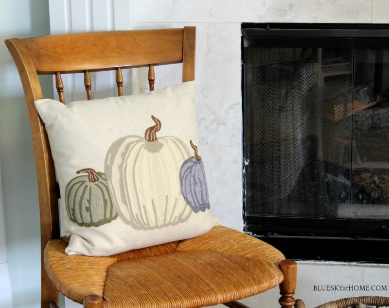 pumpkin pillow on vintage chair