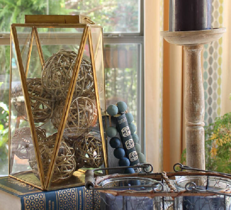 brass lantern with blue books and beads