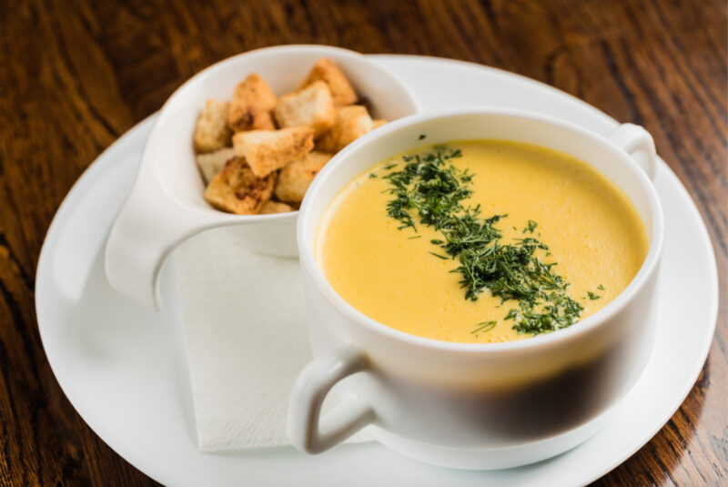 butternut squash soup garnished with chopped herbs