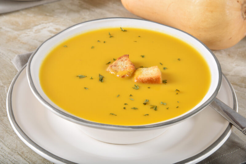 butternut squash soup with croutons and thyme leaves