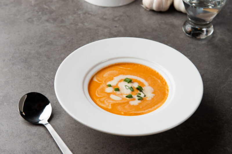 butternut squash soup with creme fraiche in white bowl