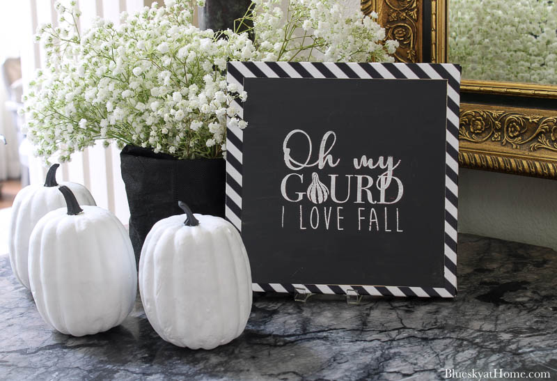 black and white fall entry sign and pumpkins