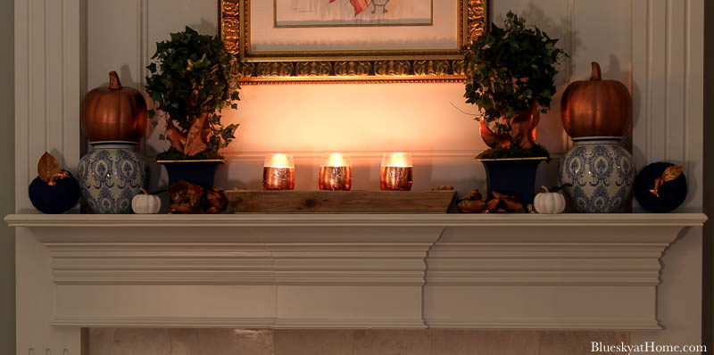 candle lit fall decorated mantel