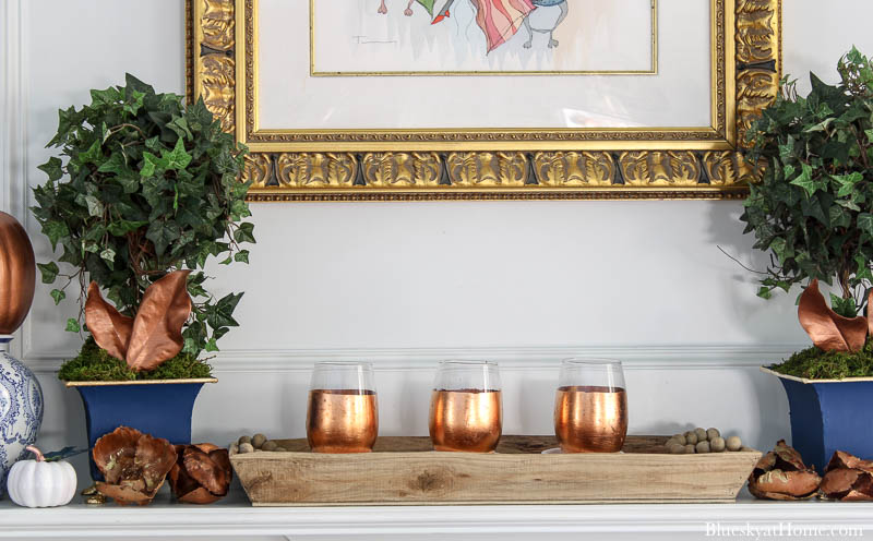 copper candle holdrs on fall decorated mantel