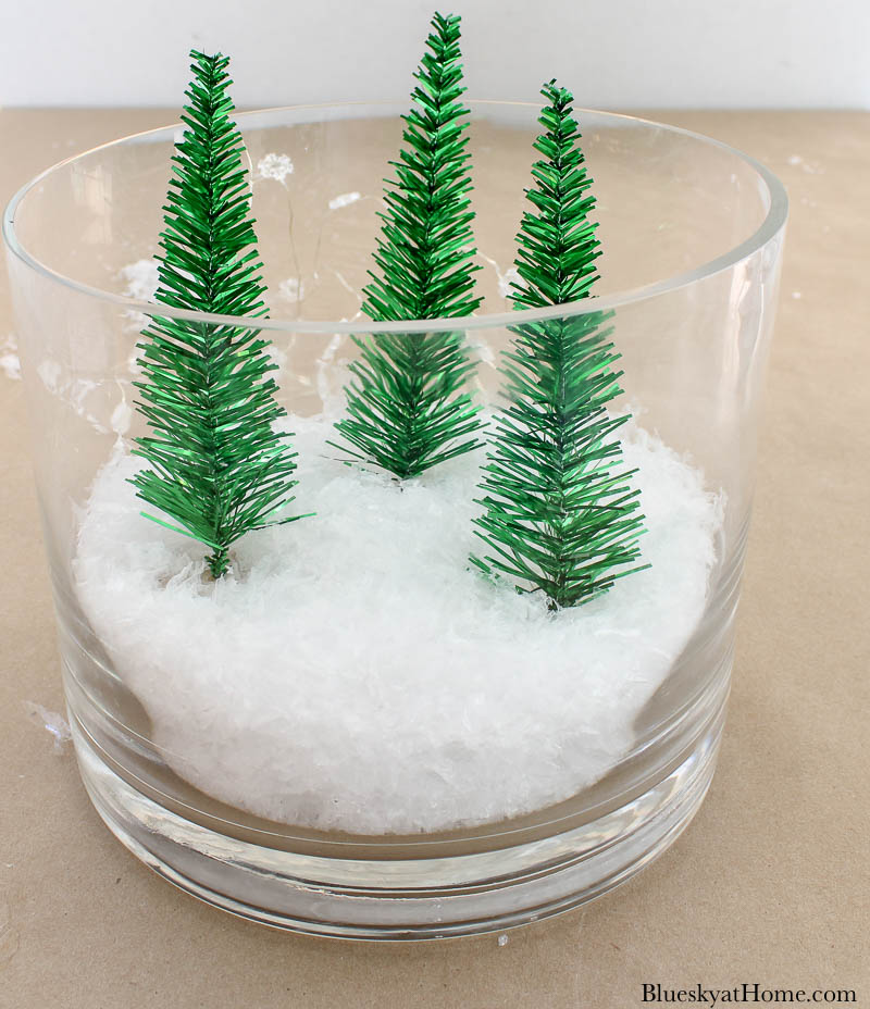 3 Christmas tres in glass vase with snow