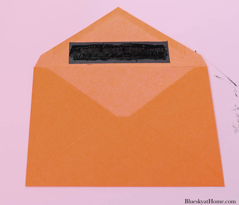 stenciling on orange envelop