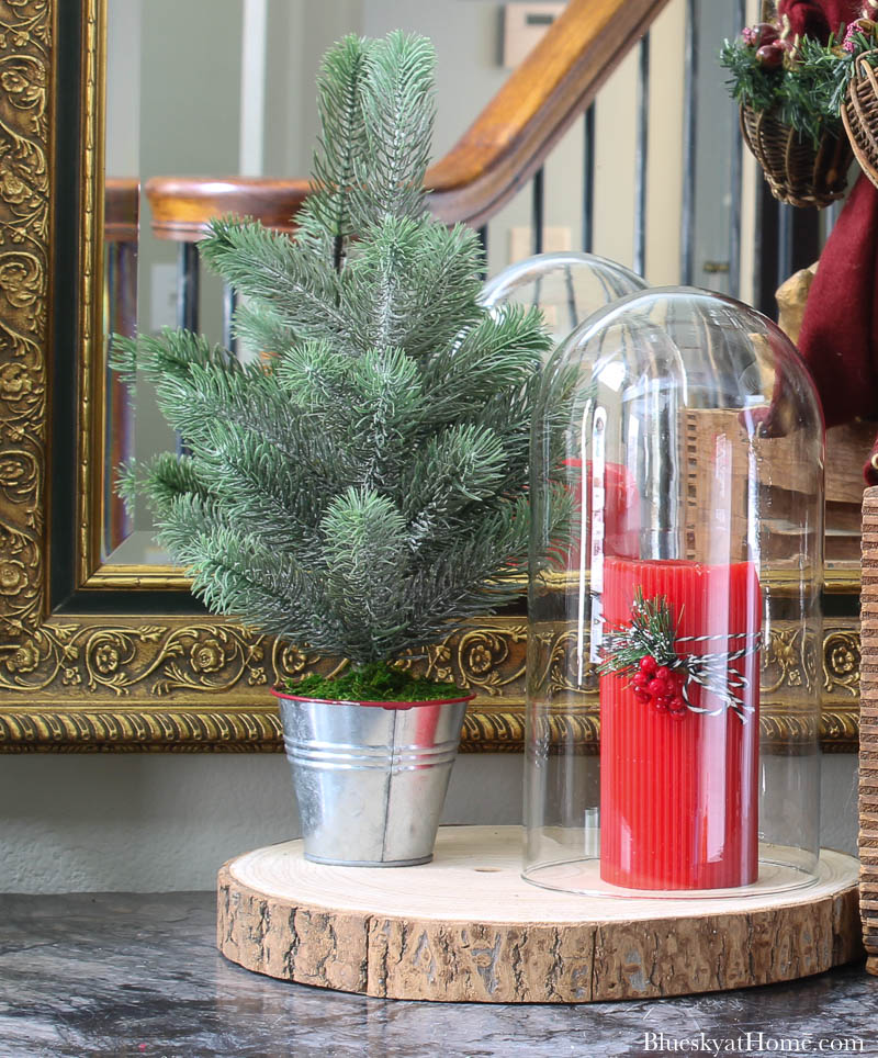 red candle and faux Christmas tree