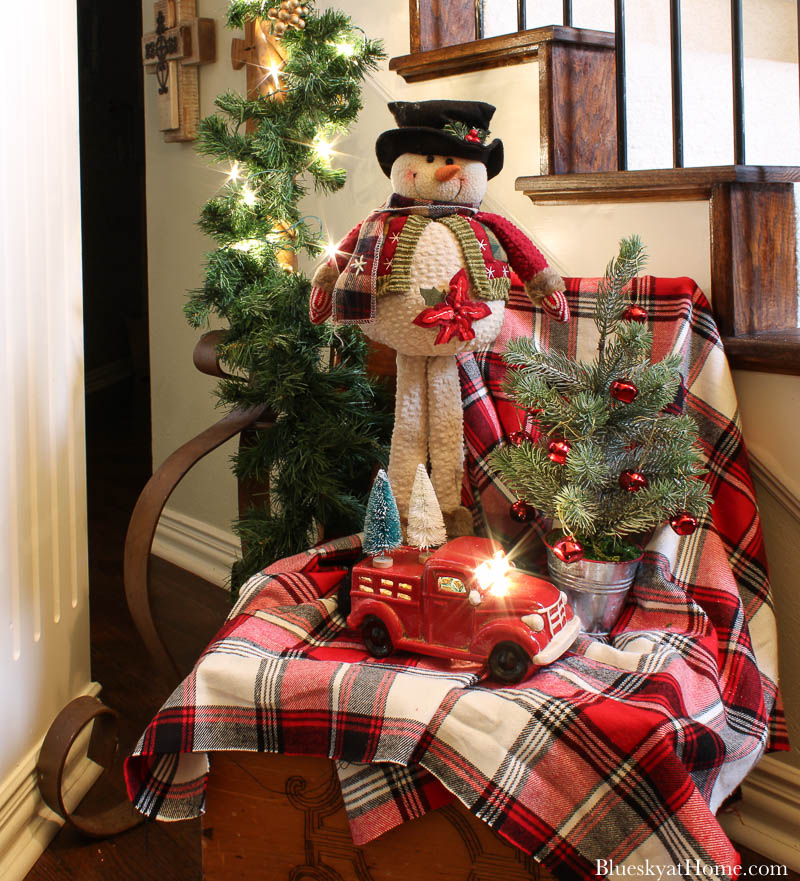 red plaid blanket with snowman and red truck