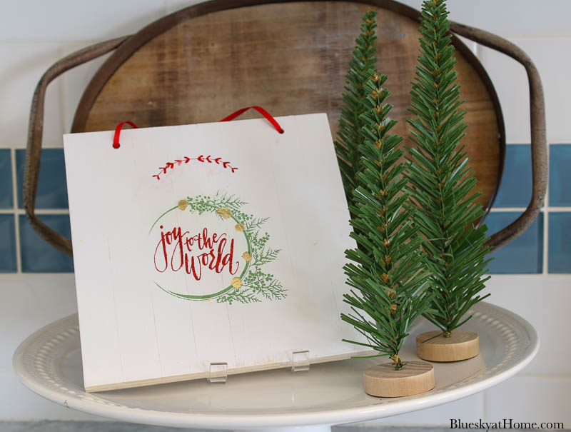 wood Christmas sign on cake stand with trees