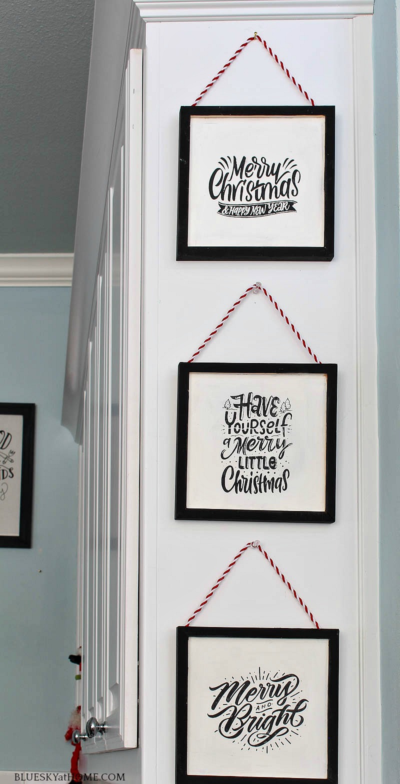 3 DIY Christmas signs hung on cabinet