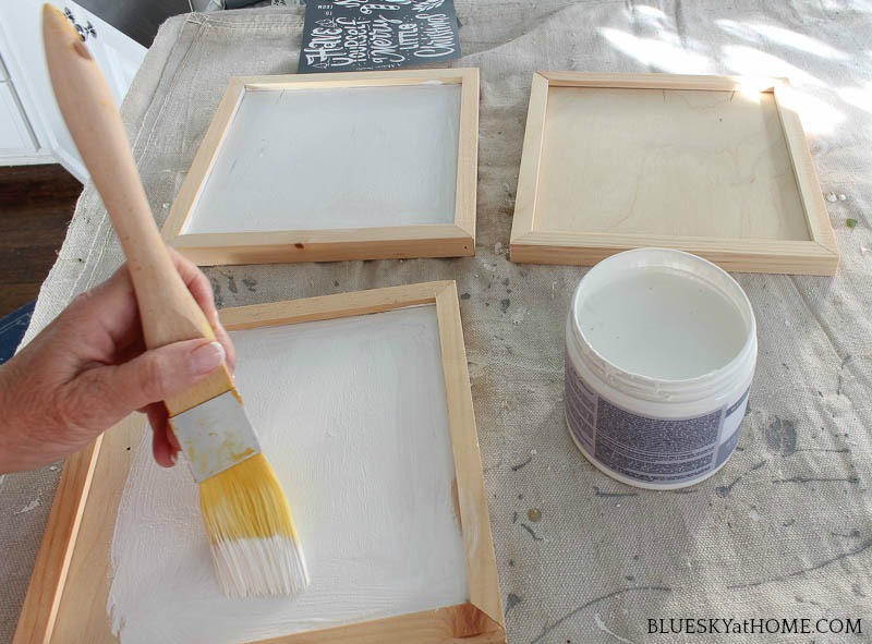 painting DIY Christmas signs.