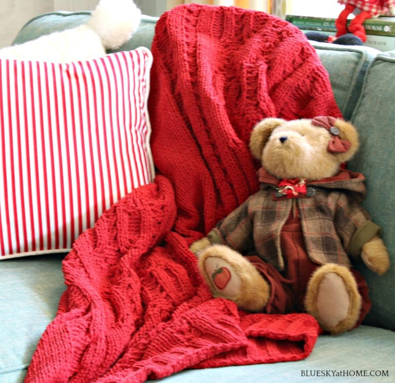 stuffed bear on red blanket