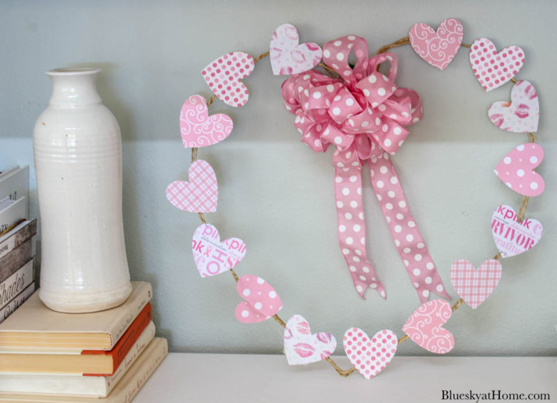 pink Valentine's heart wreath on bookshelf