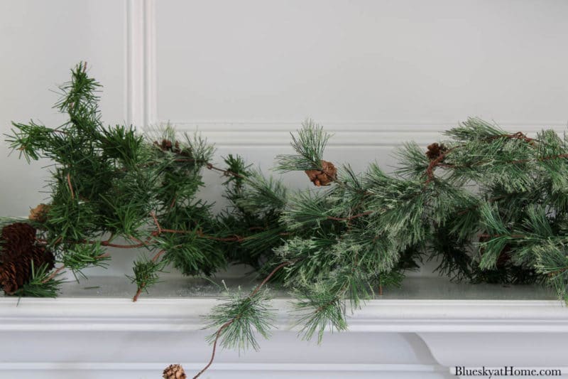 faux greenery on winter mantel