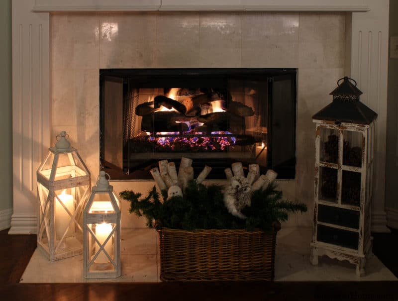 fireplace with white lanterns