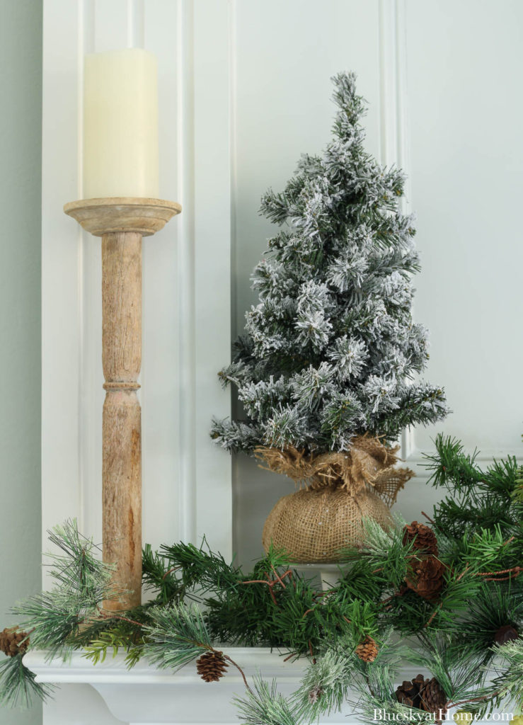 white candle with frosted tree