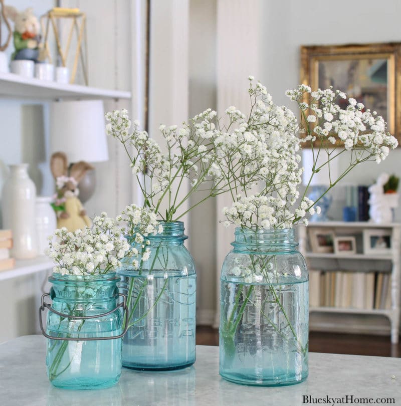 blue mason jars with white flowers