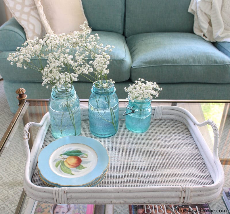 white tray with blue plates and blue mason jars