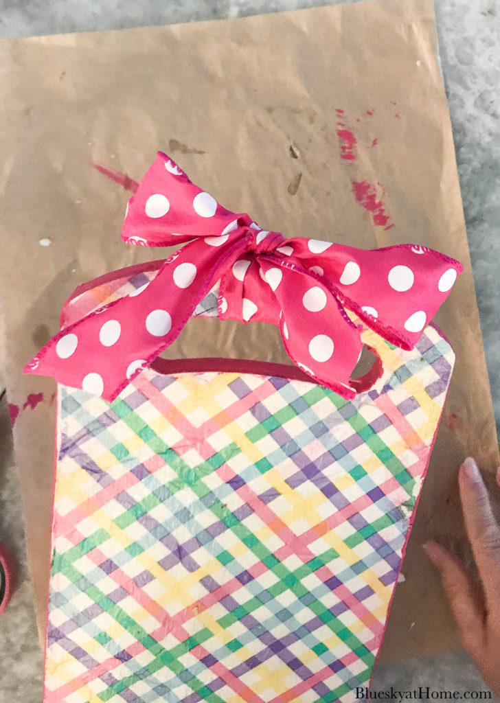 decorated spring cutting board with polka-dot pink ribbon