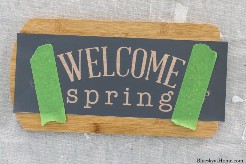 stencil DIY spring home decor on wood cutting board