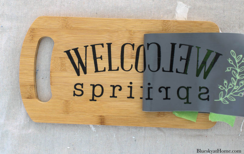 stencil DIY spring home decor on wood cutting board