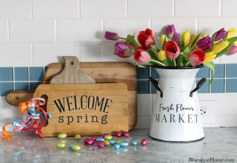 wood cutting board and container with flowers and spring home decor