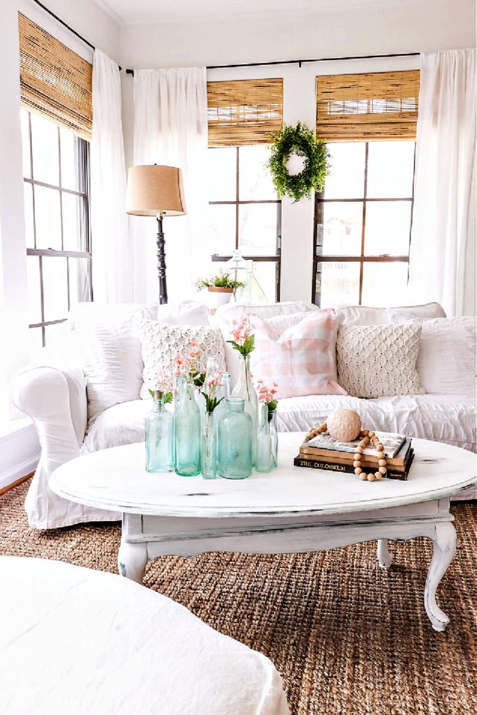 white sofa with aqua bottles