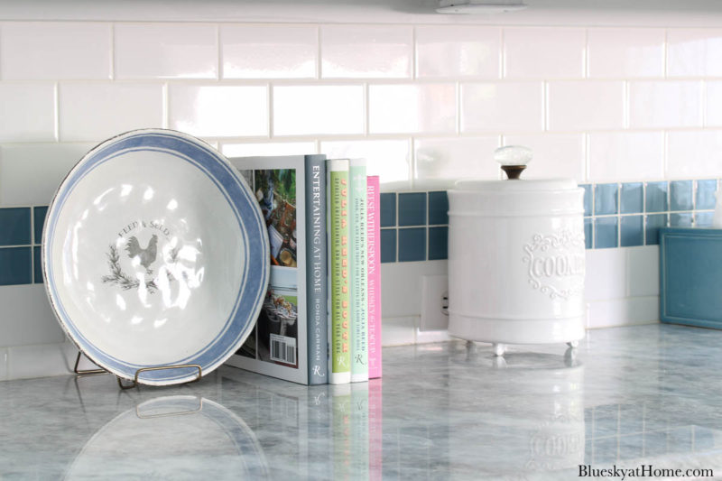 white and blue platter, books and white cookie jar