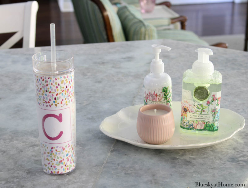 soap and lotion on white tray and tall cup