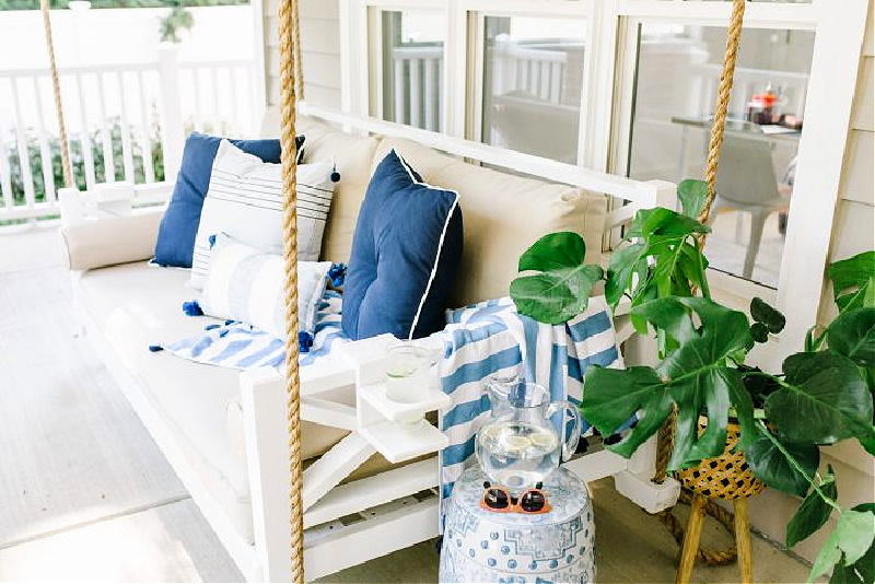 spring front porch swing with blue pillows