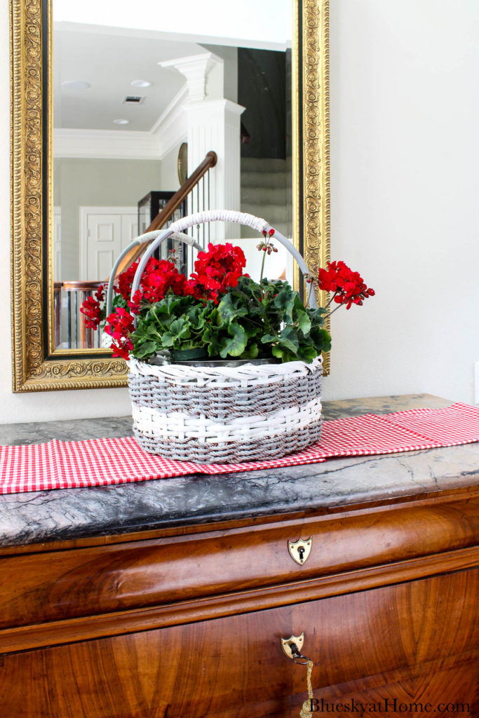 decorated basket with red geraniums