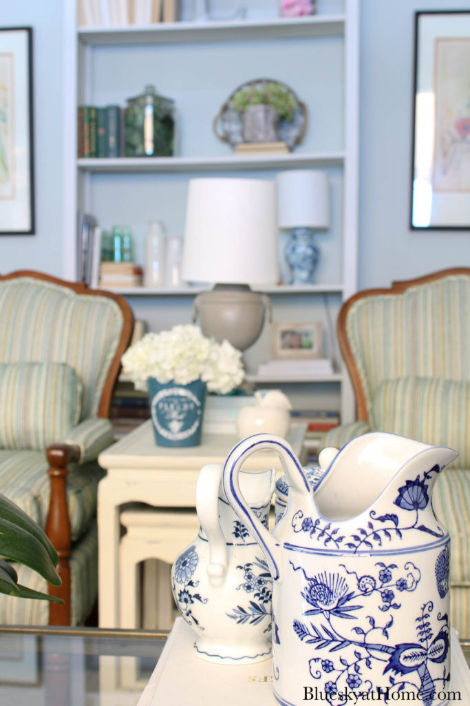 painted blue ceramic flower pot with white hydrangeas on table