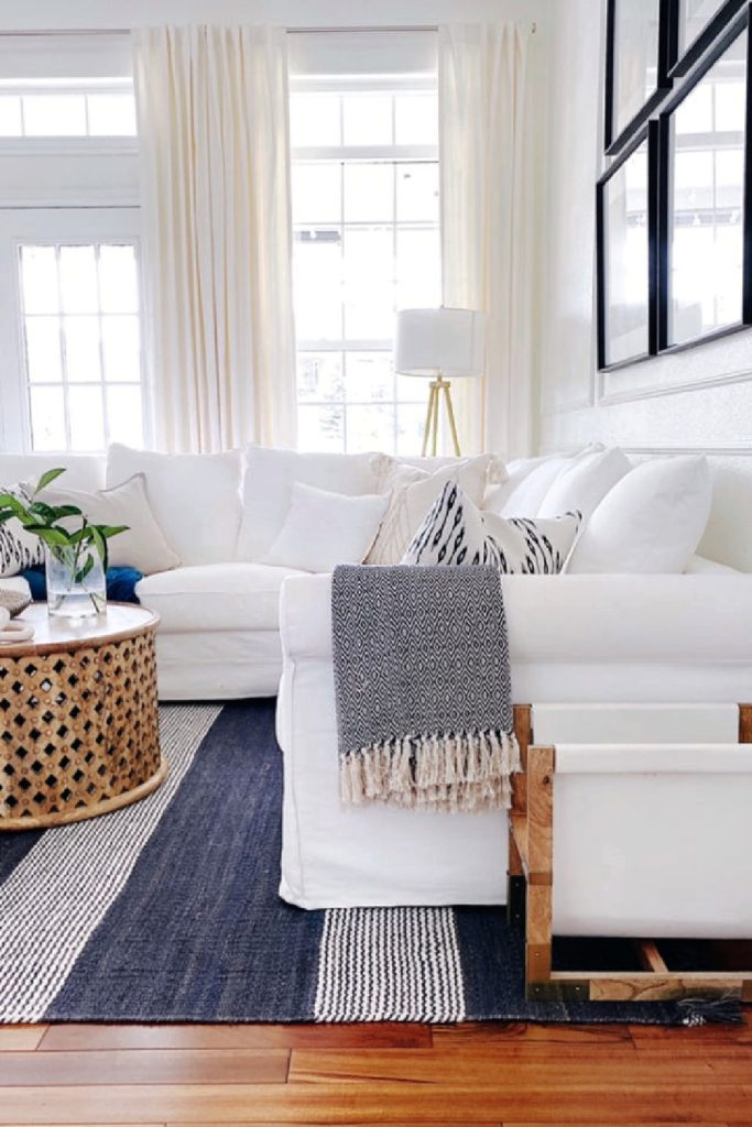 summer white sofa and blue rug and throw