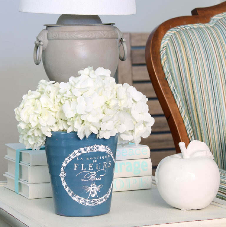 blue painted planter with white hydrangeas