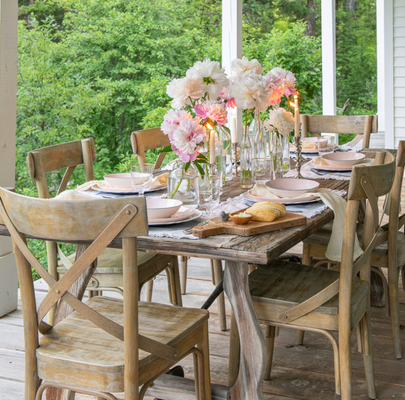 table setting pink peonies in glass bottles