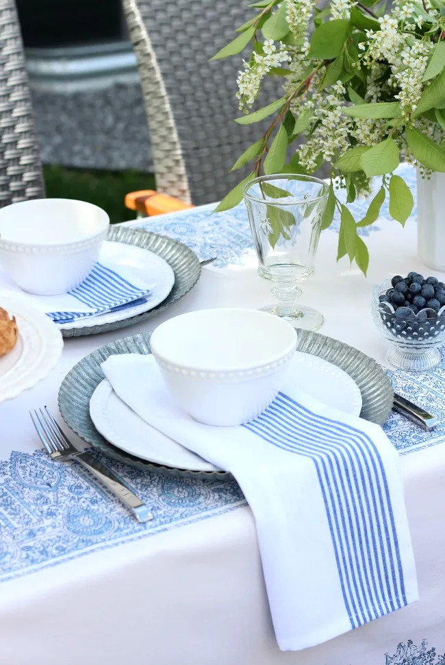 blue stripe napkins on blue paisley placemat on the table with bowl of blueberries