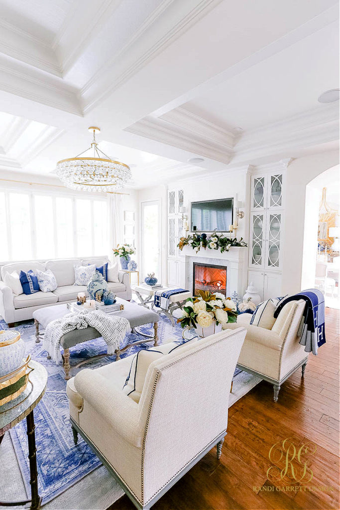 formal living room with blue rug, pillows, throw, and decorative accessories