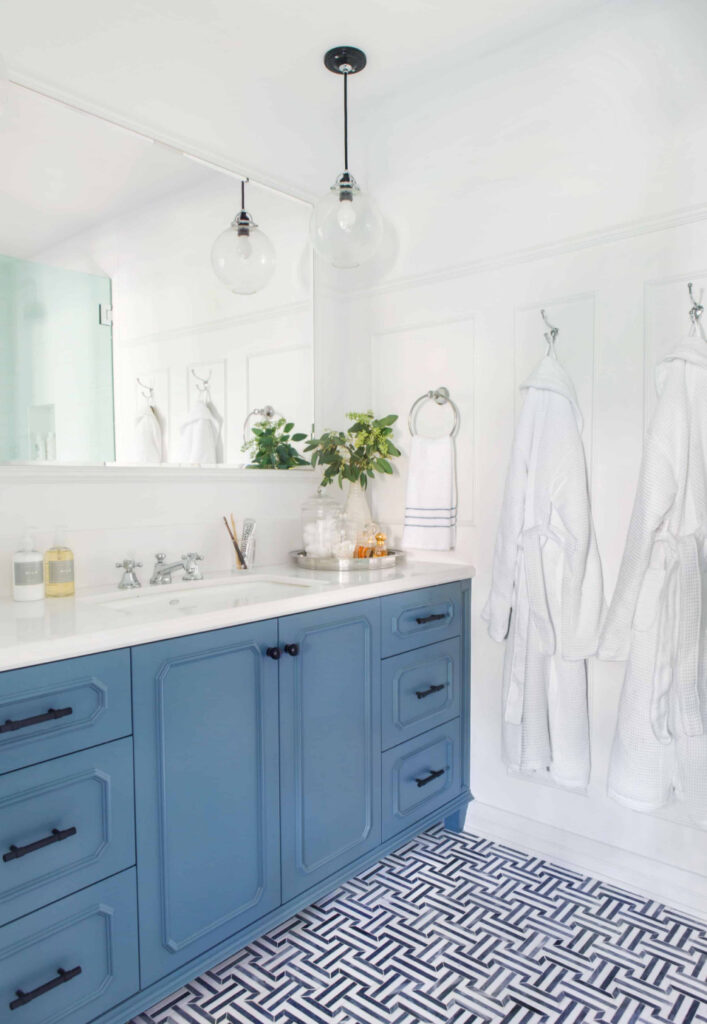  blue vanity in bathroom with blue pattern tile floor