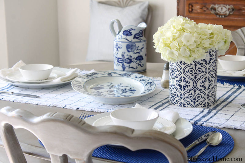 blue serving pieces and vase with white flowers