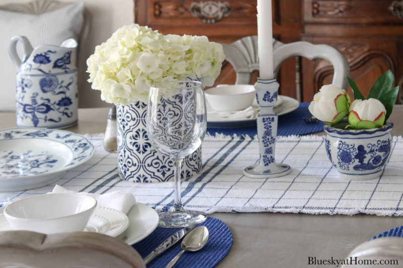blue serving pieces and vase with white flowers