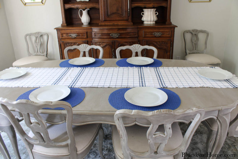 blue and white check runner on table with blue placemats wnt white plates