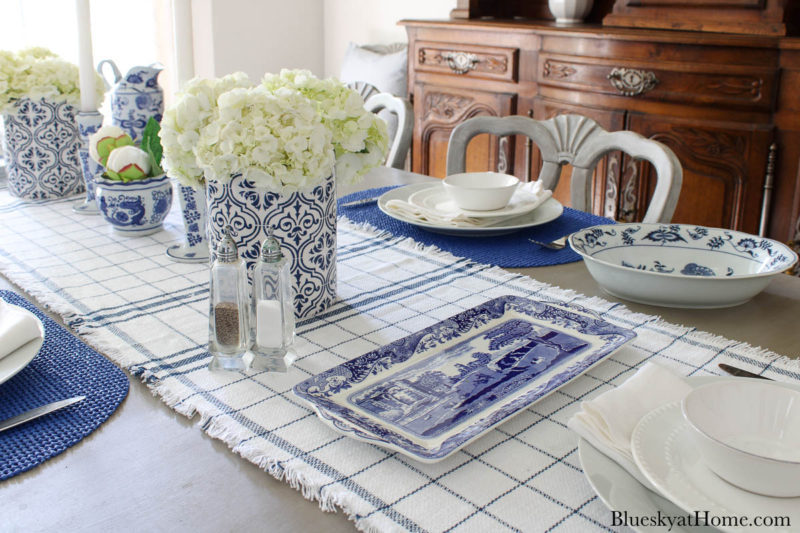 blue serving pieces and vase with white flowers