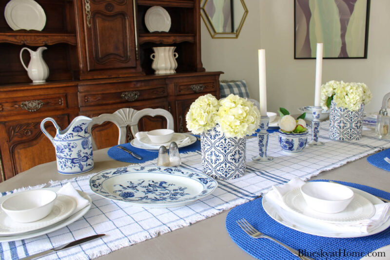  blue runner and blue plates and decorative accessories on the table