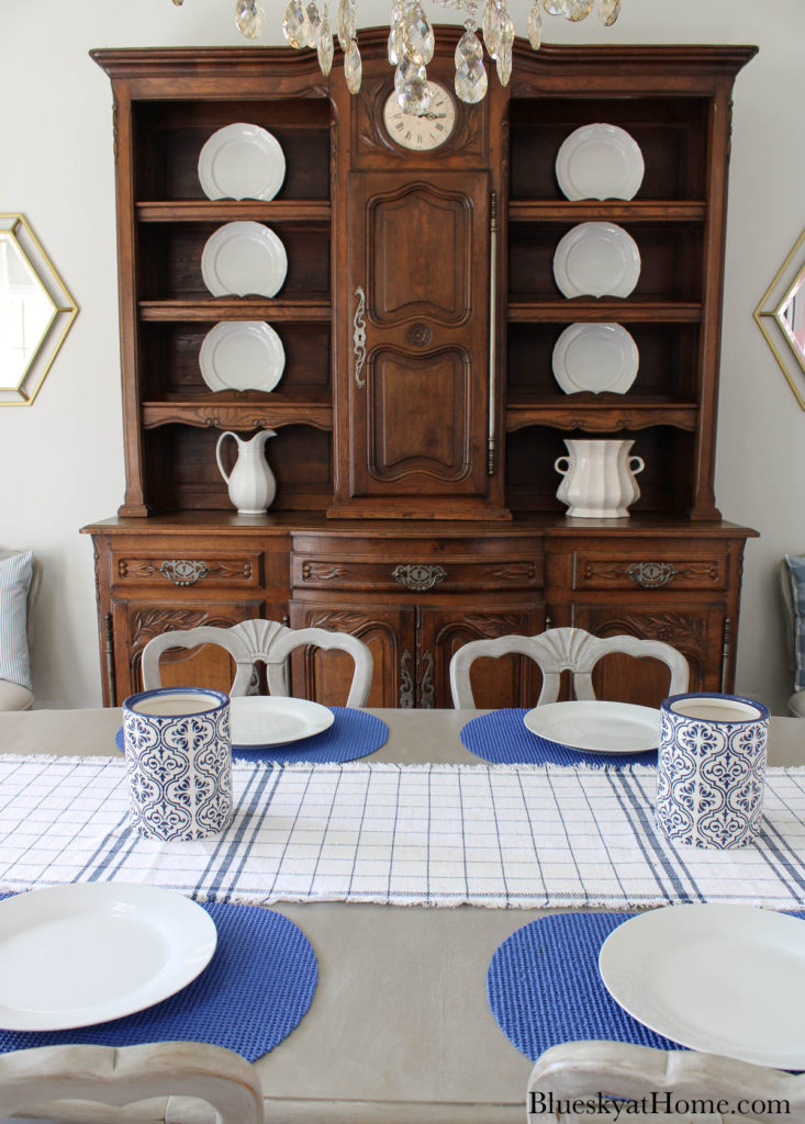 blue and white vase on blue check runner