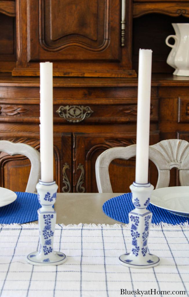 white candles in blue and white candlesticks