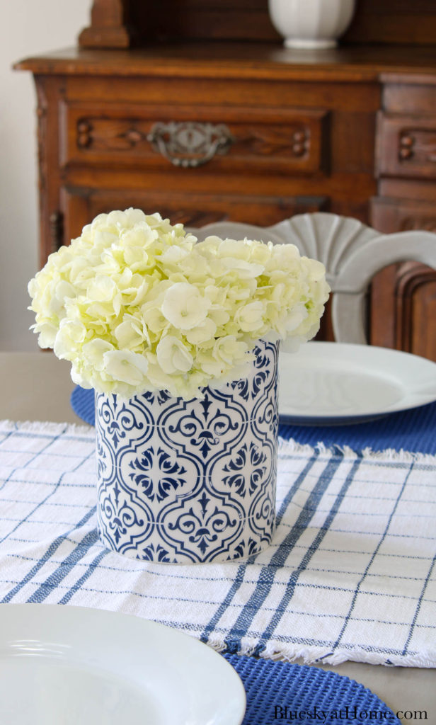 white hydrangeas in blue and white vase